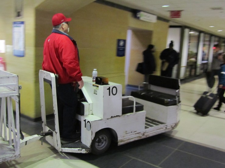 This dude is owning it. I would love to drive one of those baggage carts.